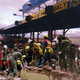 Rescue workers struggle to free survivors trapped beneath several hundred pounds of exact change.